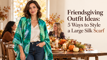 Woman wearing a green and teal printed scarf over an ivory blouse and jeans at a Friendsgiving dinner with friends.