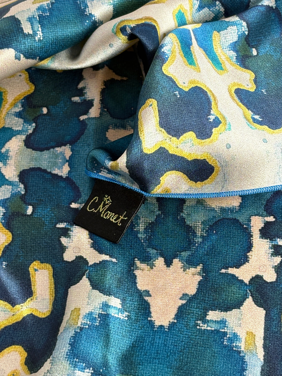 Close-up of a patterned fabric with a visible brand tag.