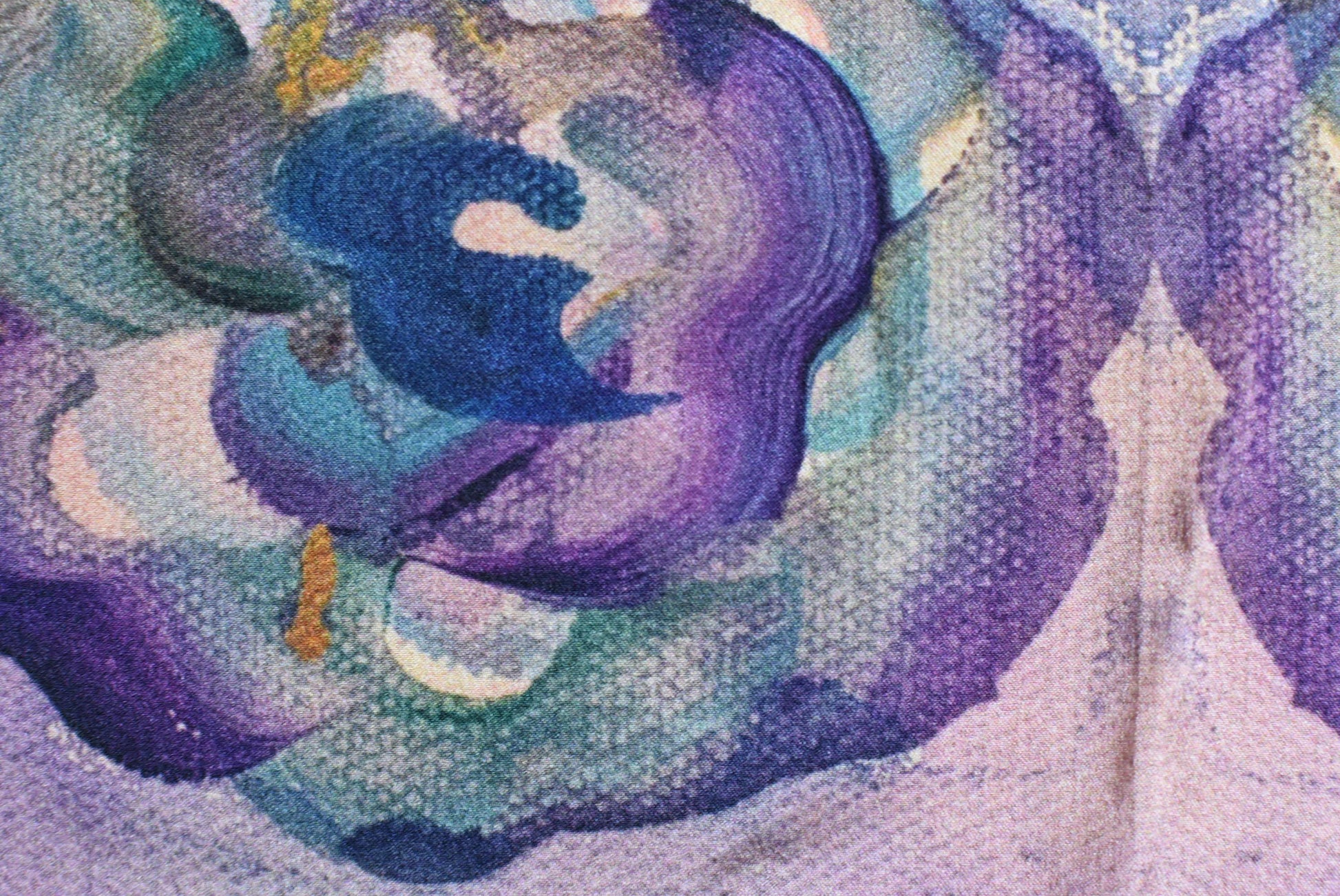 Close-up of a textured fabric with swirling purple and blue patterns