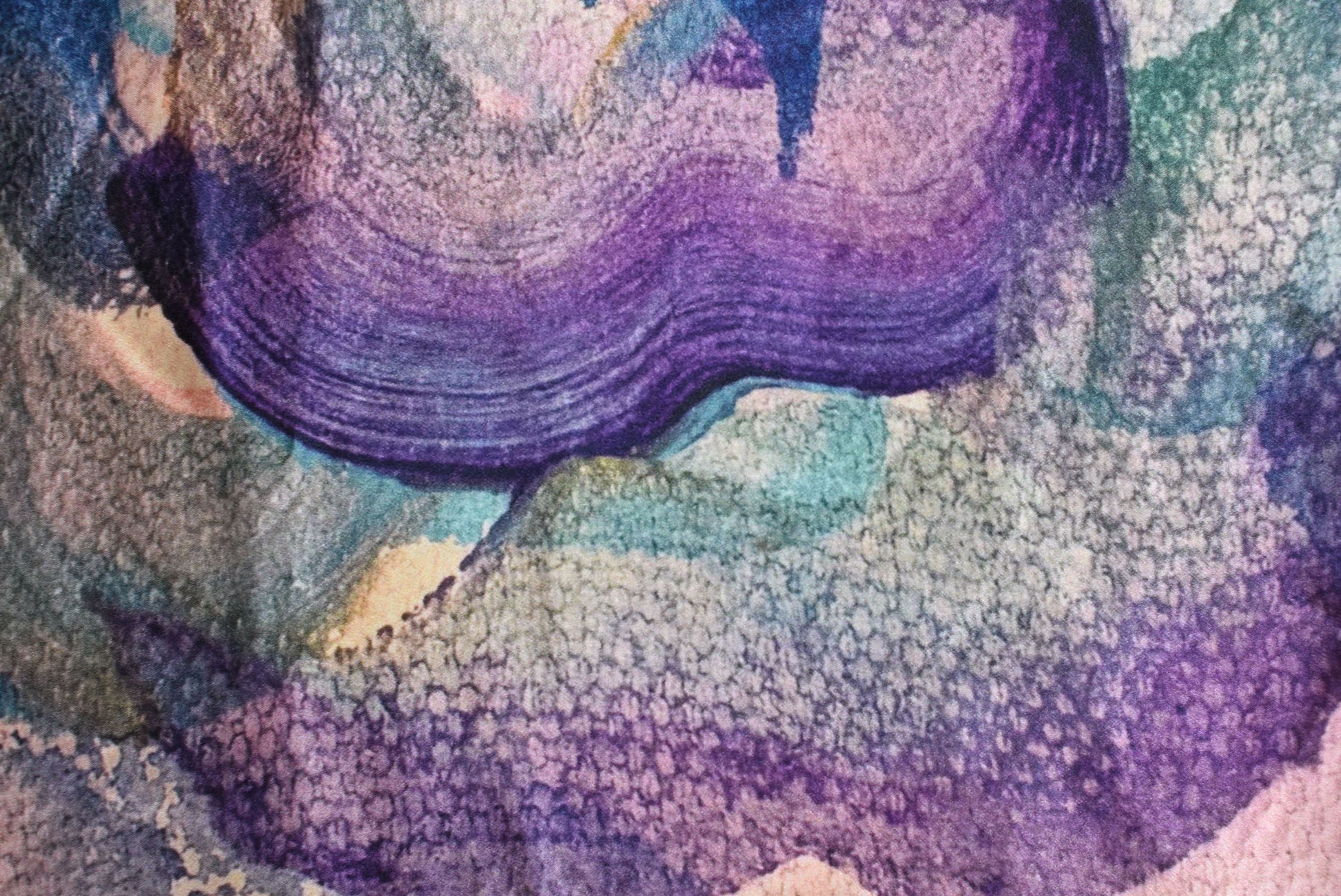 Colorful abstract pattern with shades of purple, blue, and green.