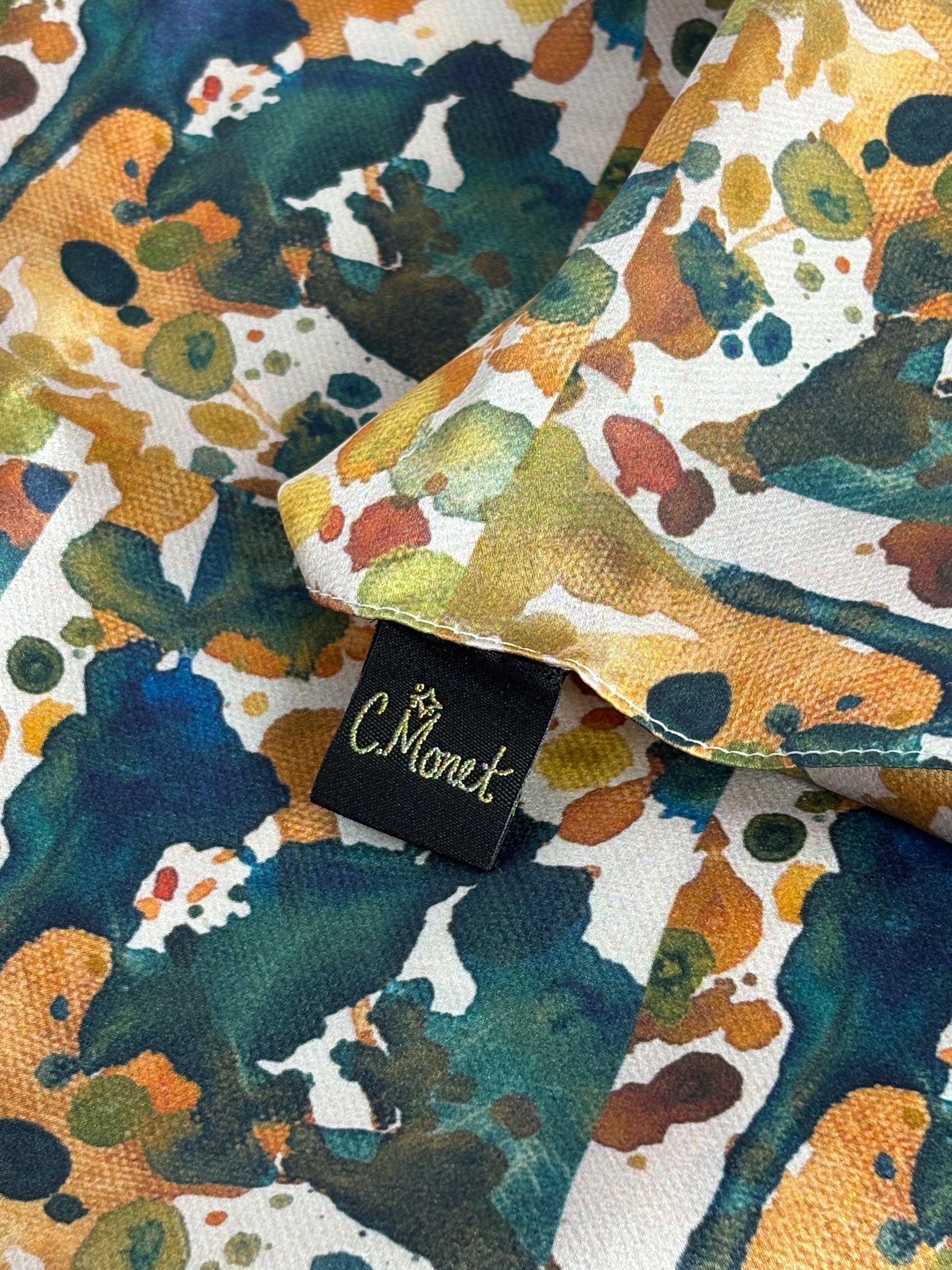 Colorful fabric with a pattern and a black tag with 'C. Wonder' branding.