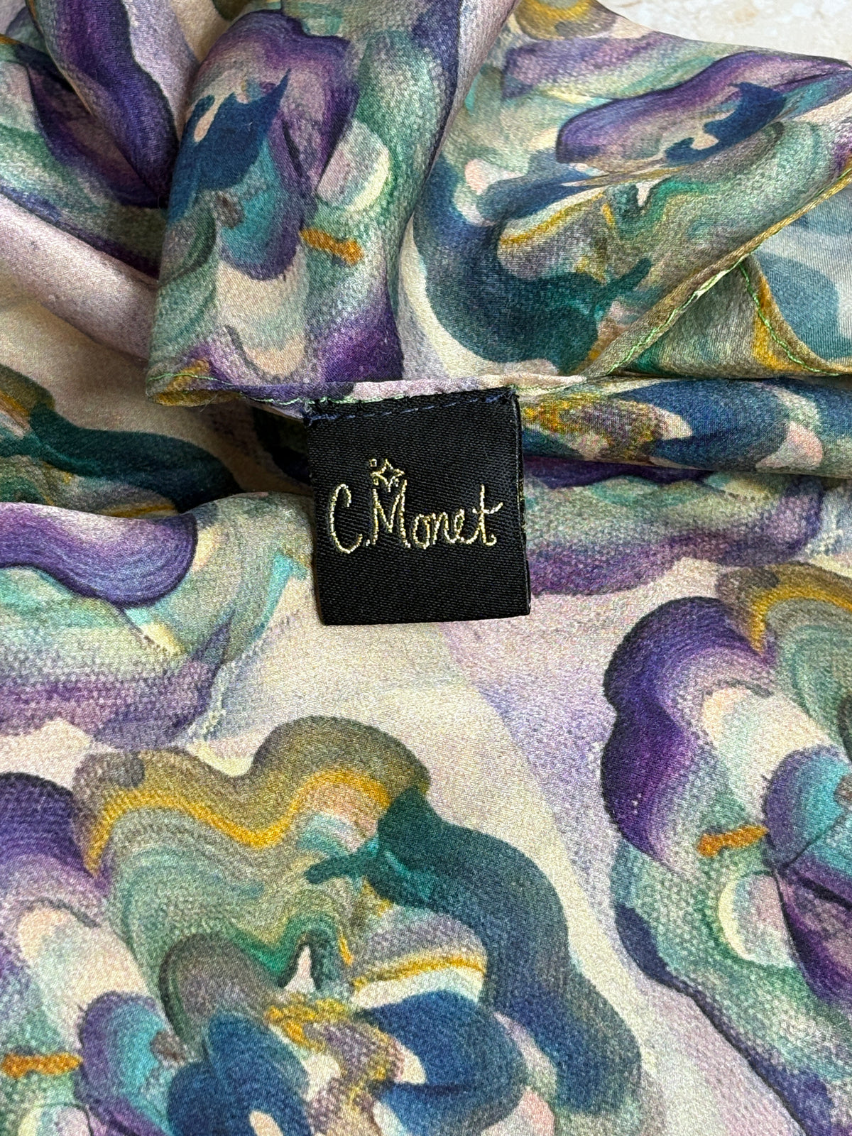 Colorful fabric with floral pattern and a visible brand tag.
