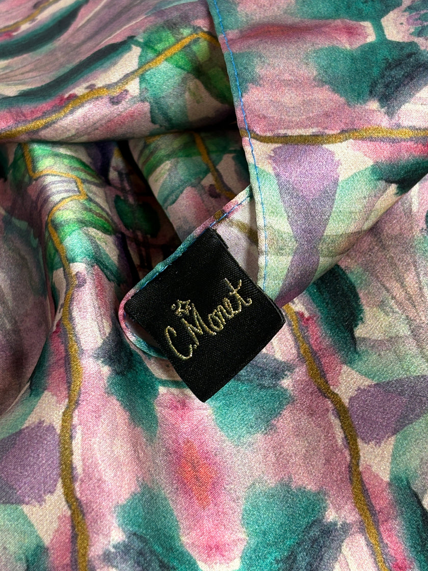 Close-up of a floral-patterned fabric with a black label featuring gold text.