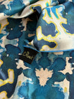 Close-up of a patterned fabric with a visible brand tag.