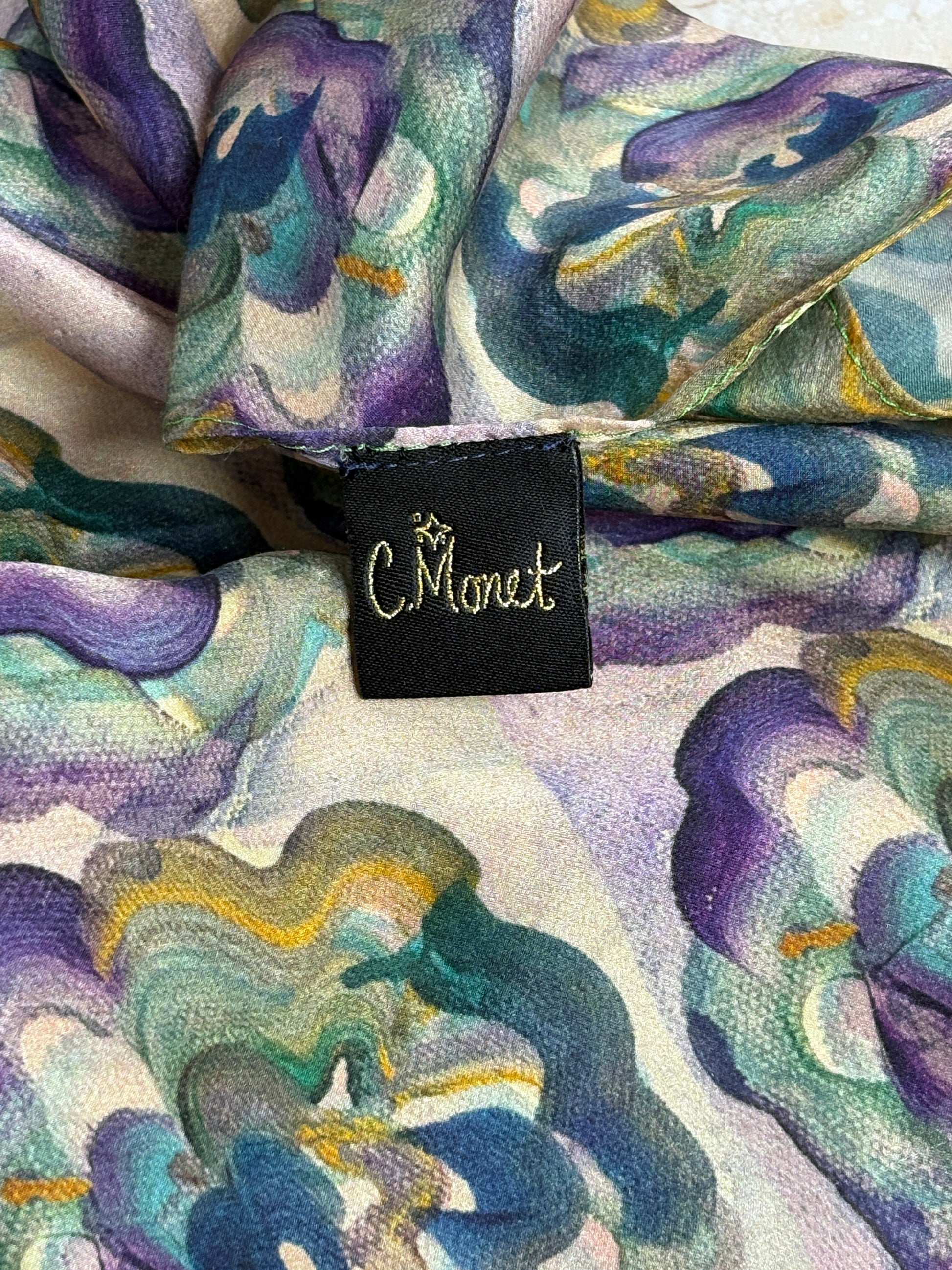 Colorful fabric with floral pattern and a visible brand tag.