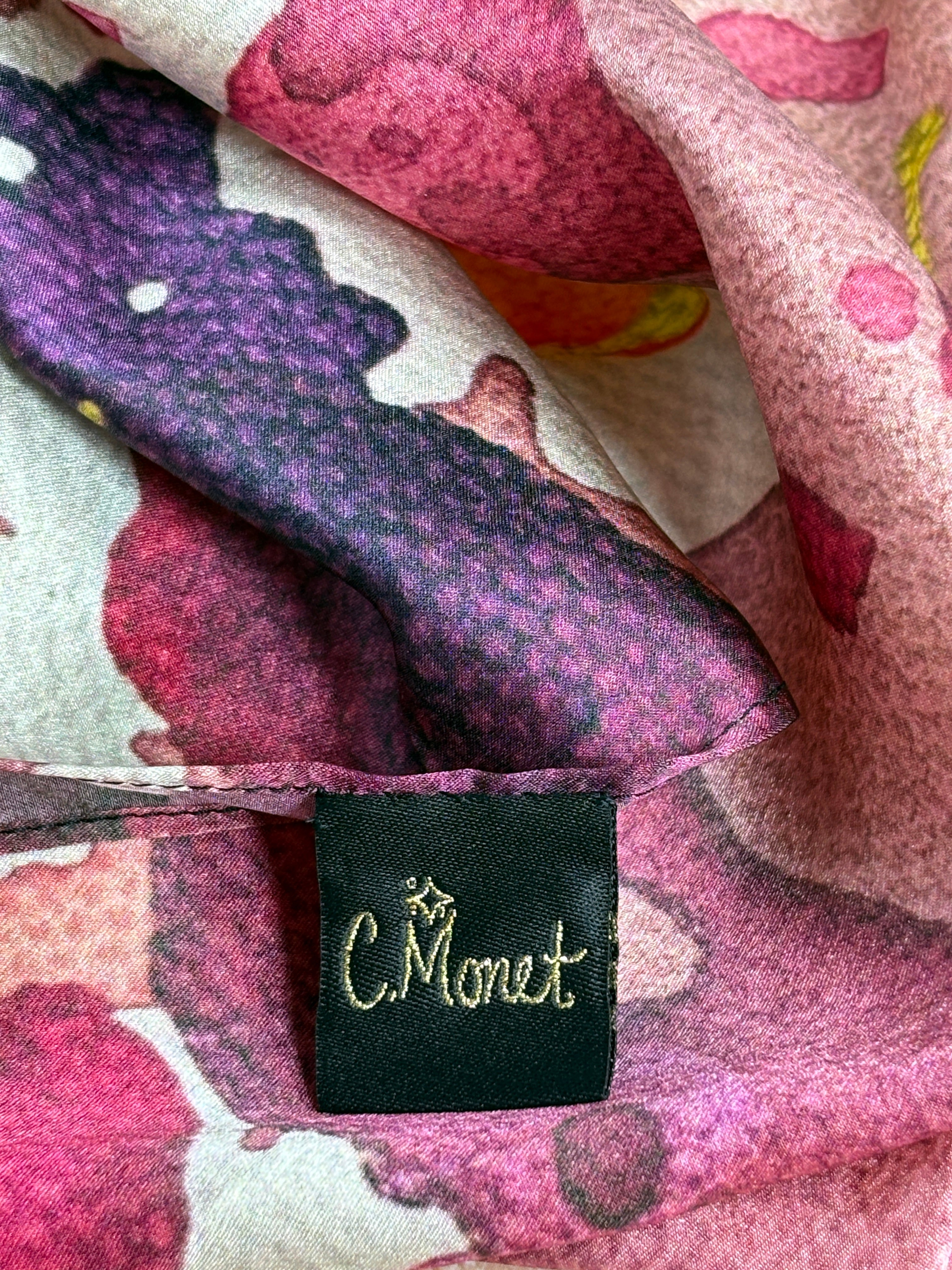 Close-up of a floral-patterned fabric with a C. Monet label.