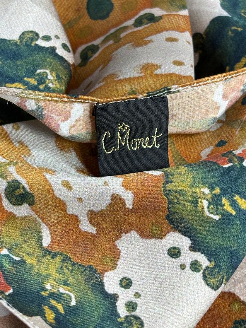 Close-up of a fabric with a colorful pattern and a brand tag.