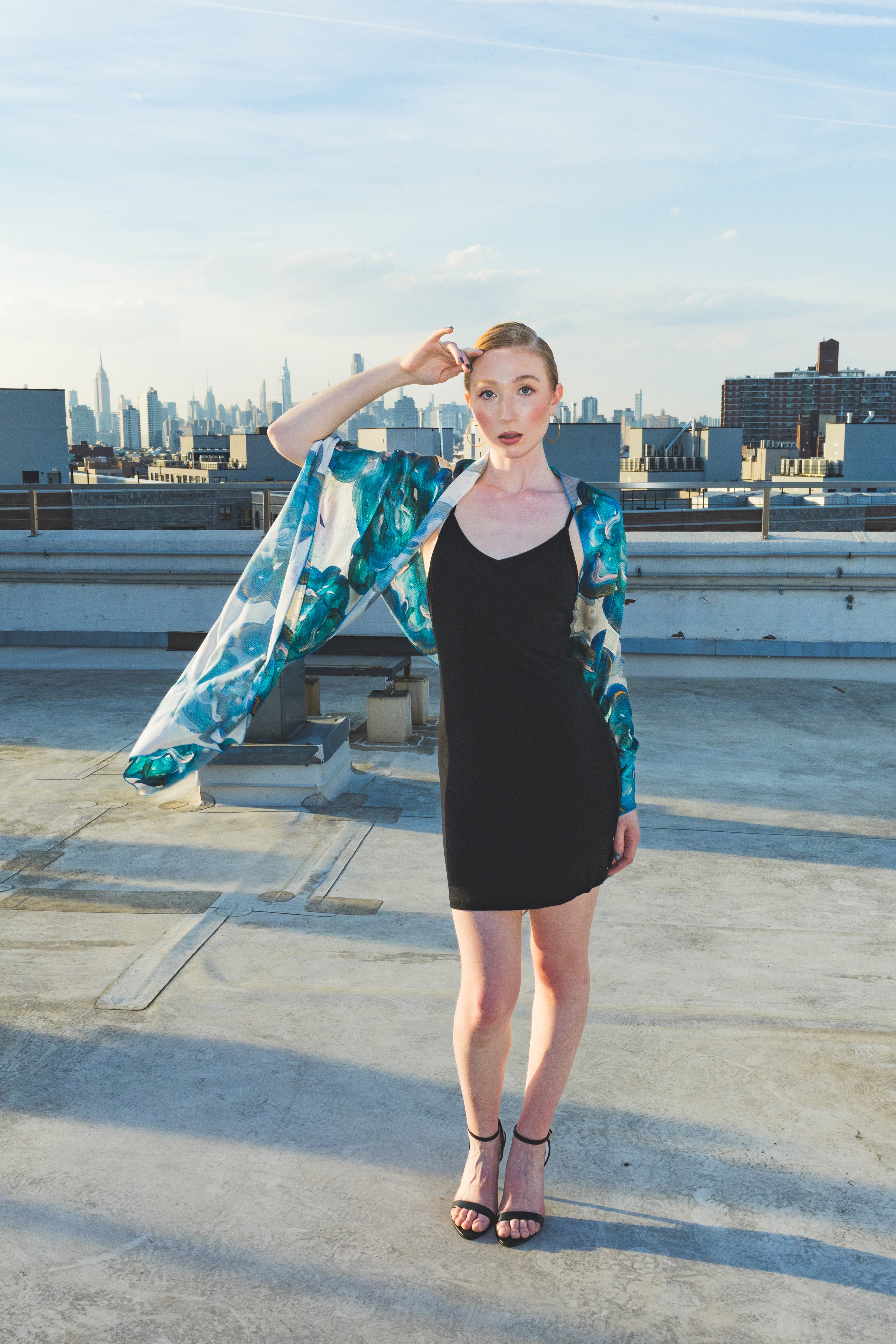 Woman on a rooftop with a cityscape 