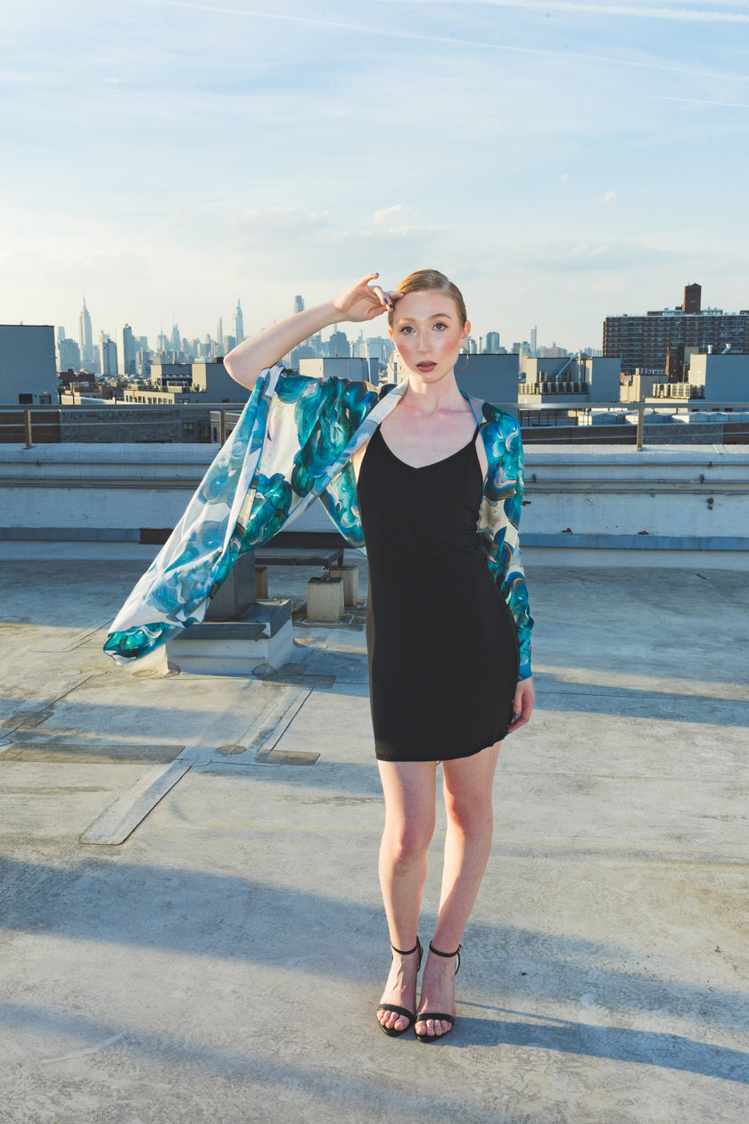 Woman on a rooftop with a cityscape 