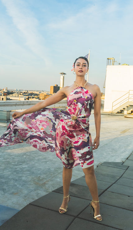 Woman in a floral dress standing 