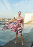 Woman in a floral dress standing 
