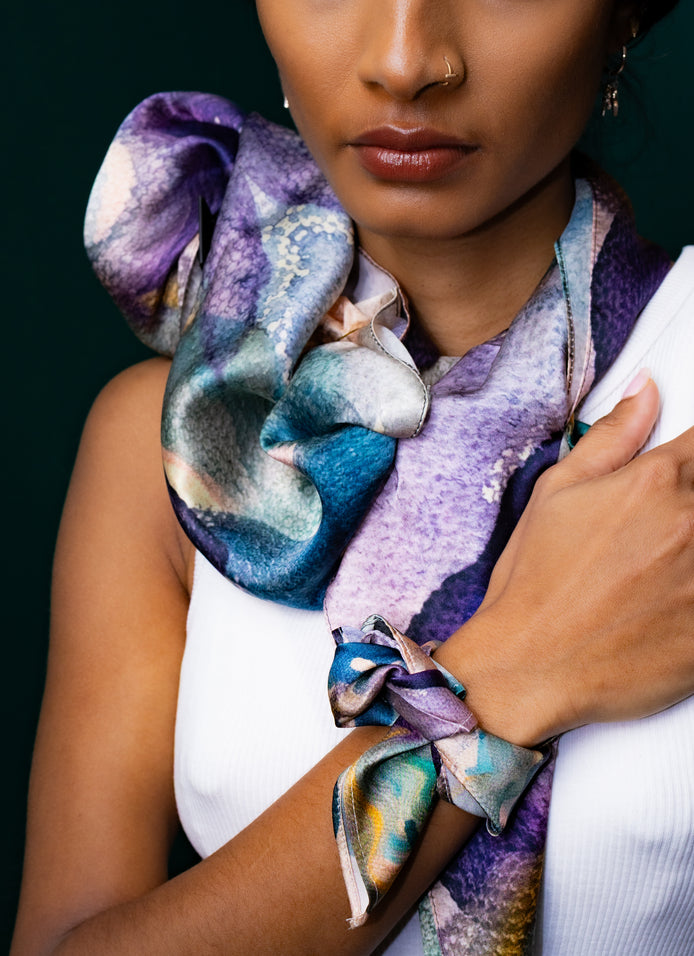 Purple and blue silk scarf worn as neck and wrist accessory