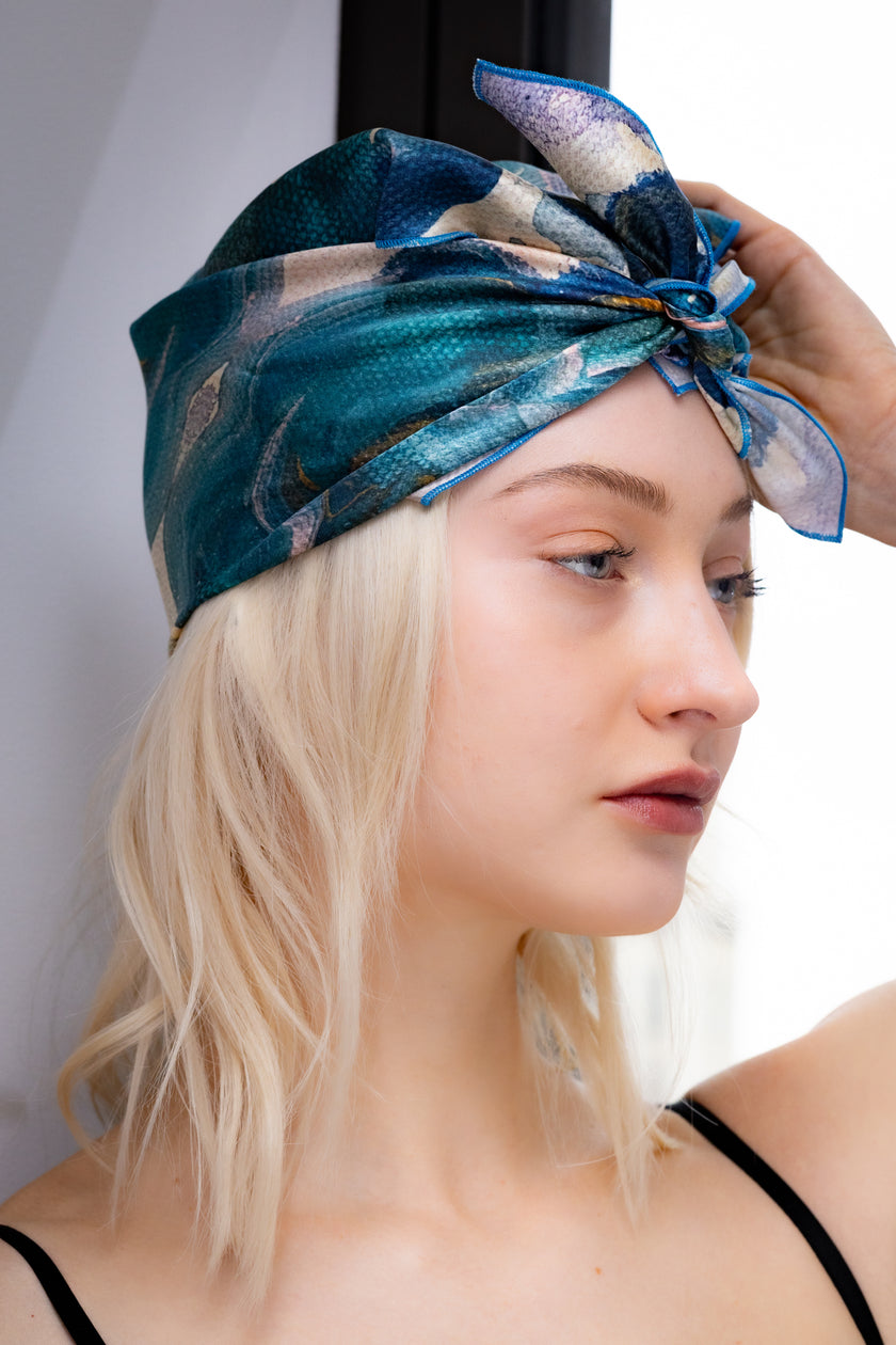 Woman wearing a blue patterned headscarf 