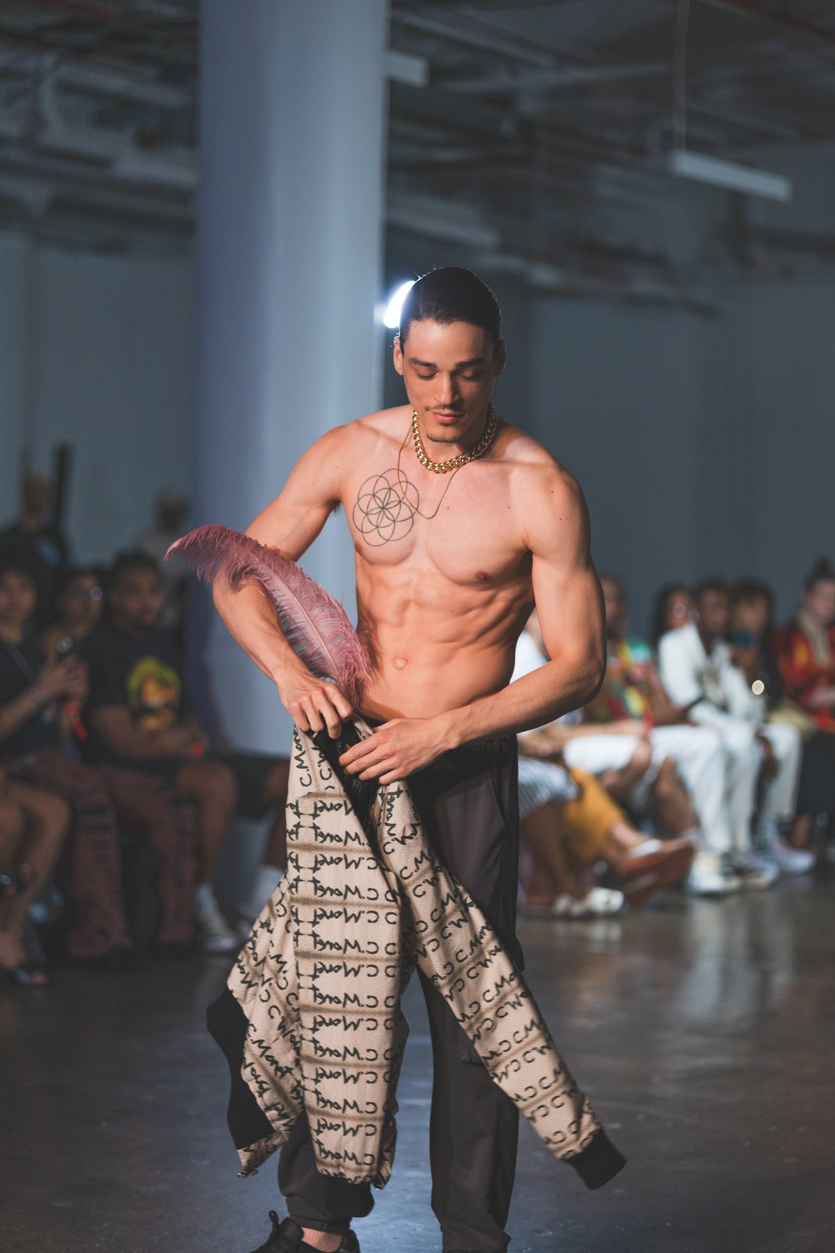 Model walking on a runway with a patterned garment, 