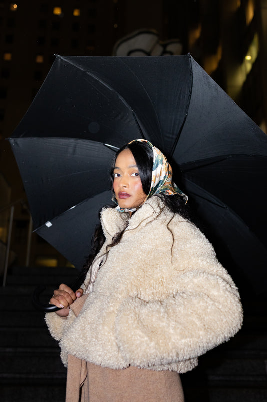 Person holding a black umbrella 