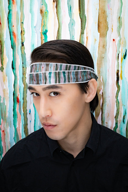 Person wearing a headband with a colorful abstract background