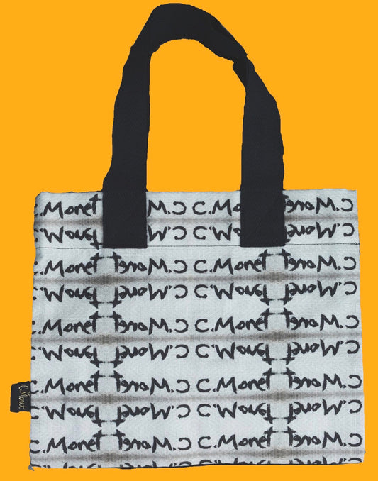 A white tote bag with black handles and an all-over repeating black C.Mont logo print, shown against a solid orange background.