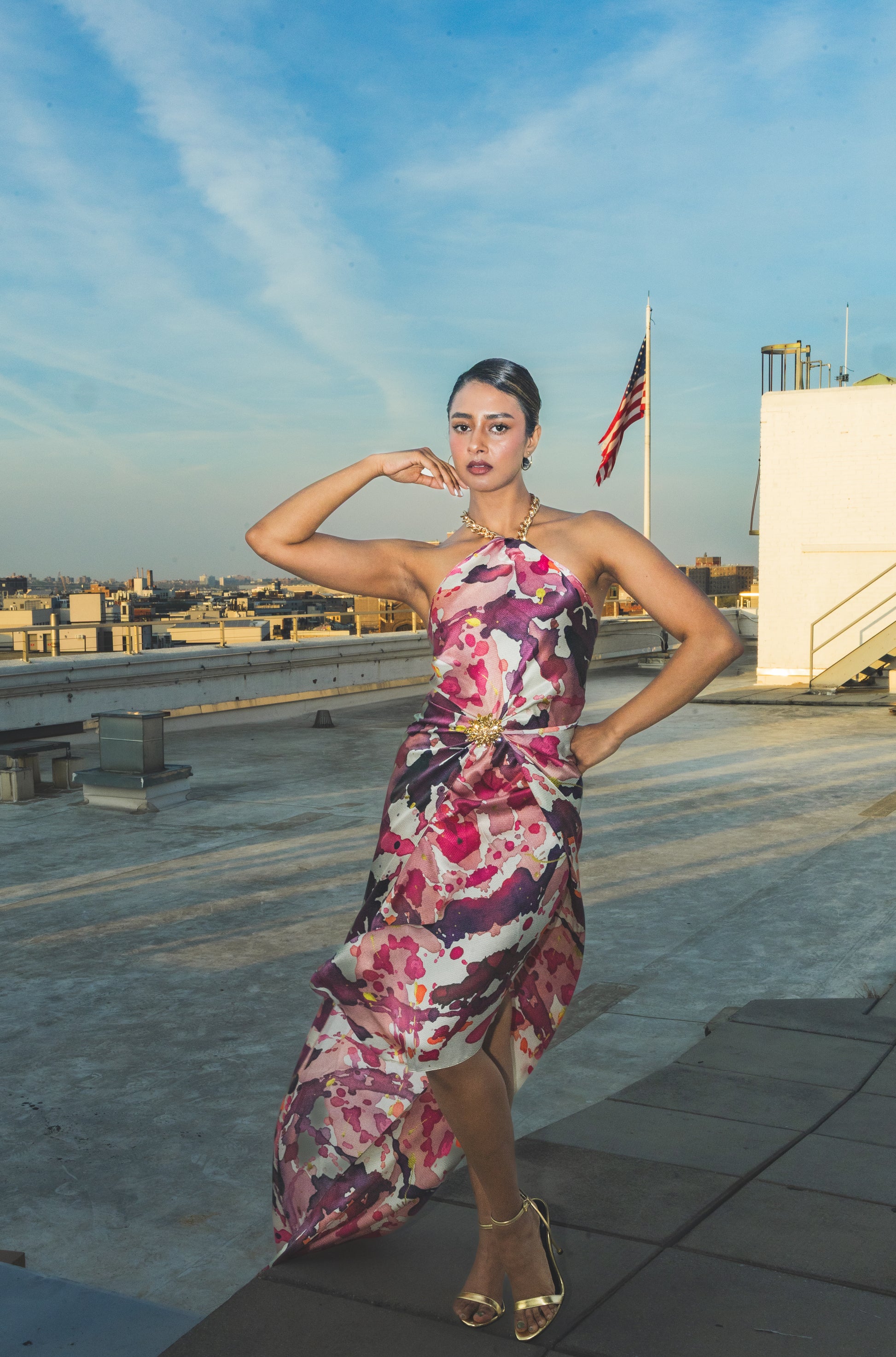 Woman in a floral dress on a rooftop 