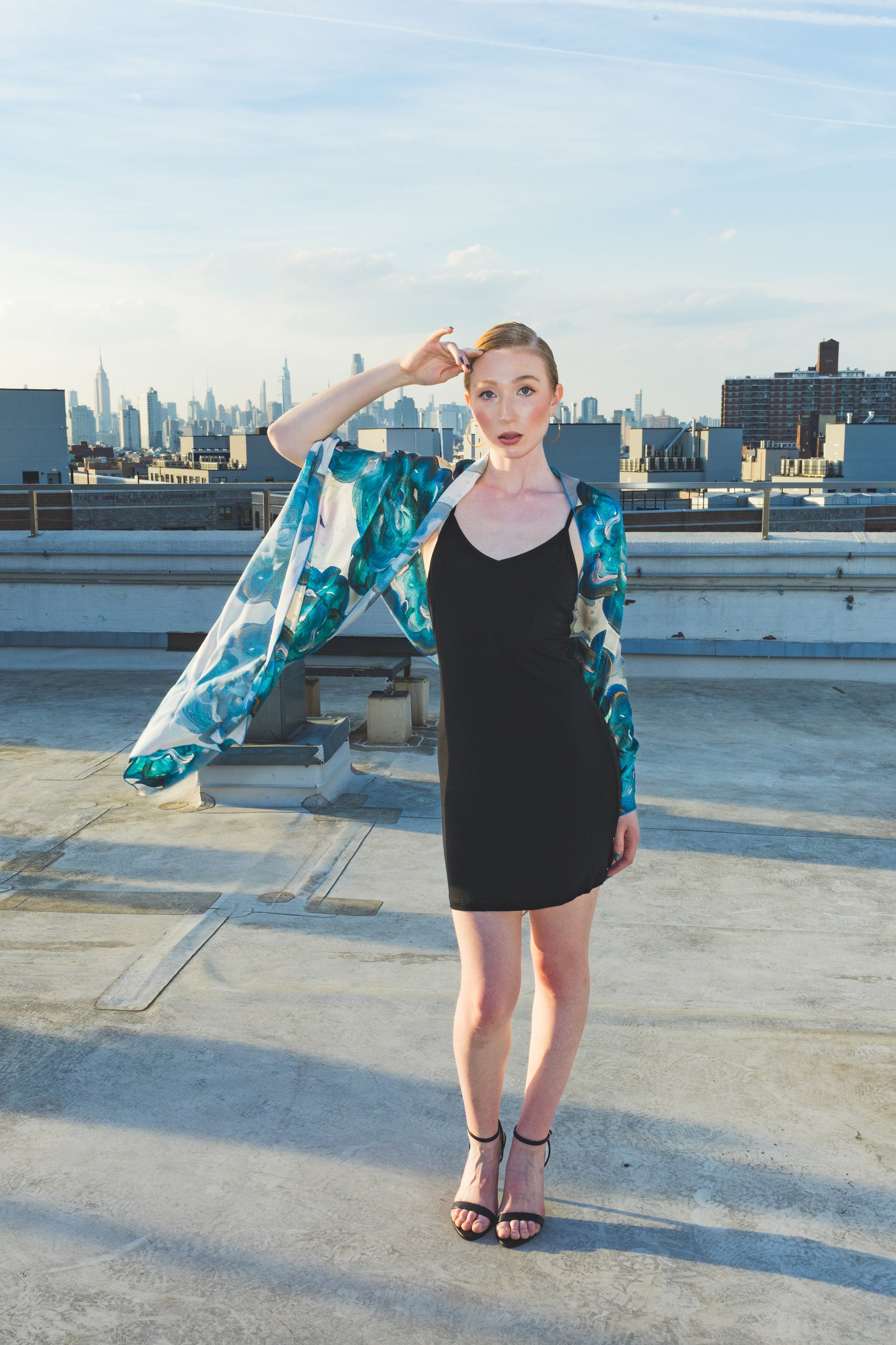 Woman on a rooftop with a cityscape 