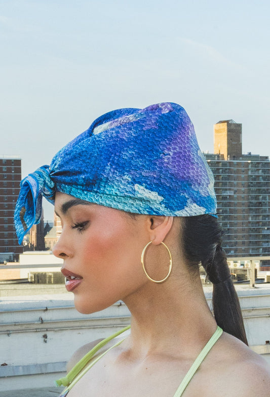 Woman wearing a blue and purple patterned headscarf 