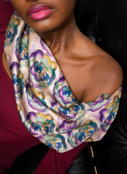 Woman wearing a colorful floral scarf with a blurred background