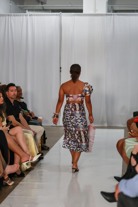 Back runway view of the Andromeda bikini top styled with a printed wrap.