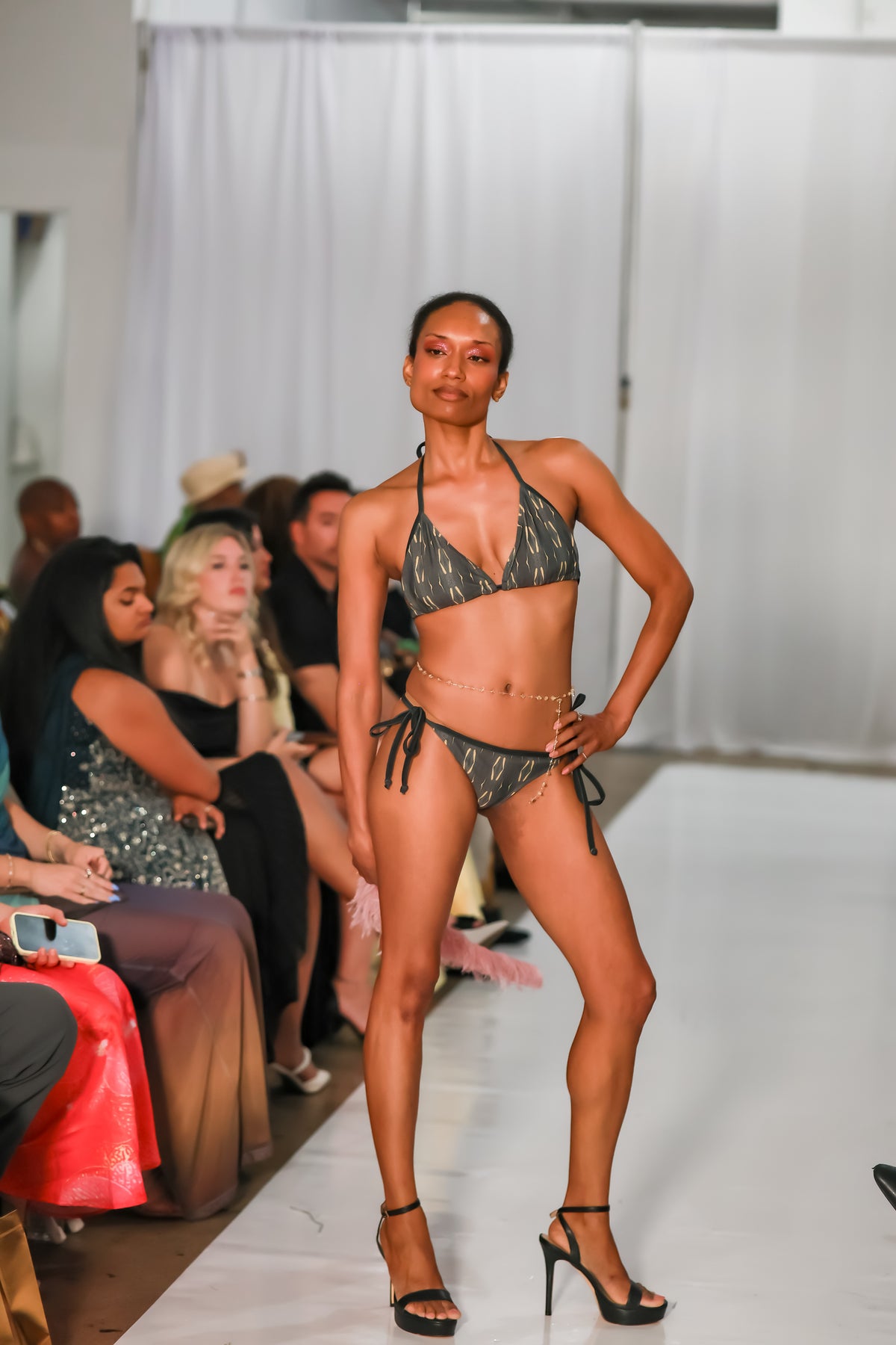 Model wearing the B & G string bikini top with coordinating bottoms on a runway.