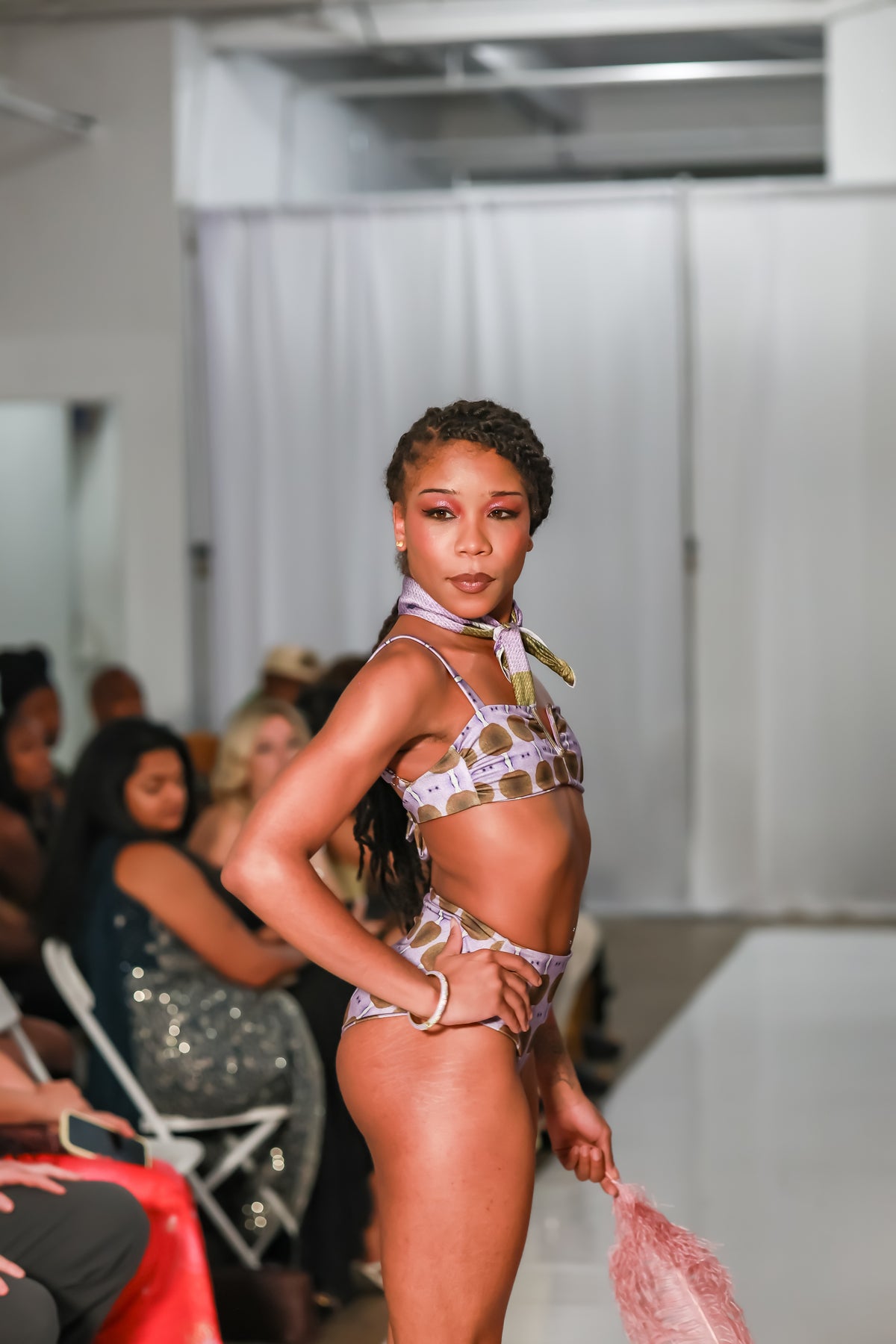 Side view of a bralette swim top with a cutout neckline styled with matching bikini bottoms on the C. Monet Atelier runway