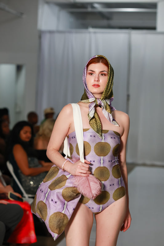 Lavender one piece swimsuit with side tie cutout detail and matching headscarf