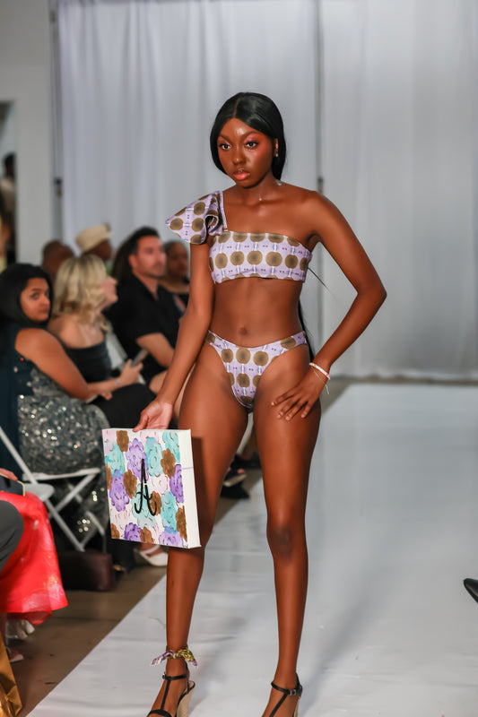 One shoulder ruffle bikini top with matching lavender print bottoms at a fashion show
