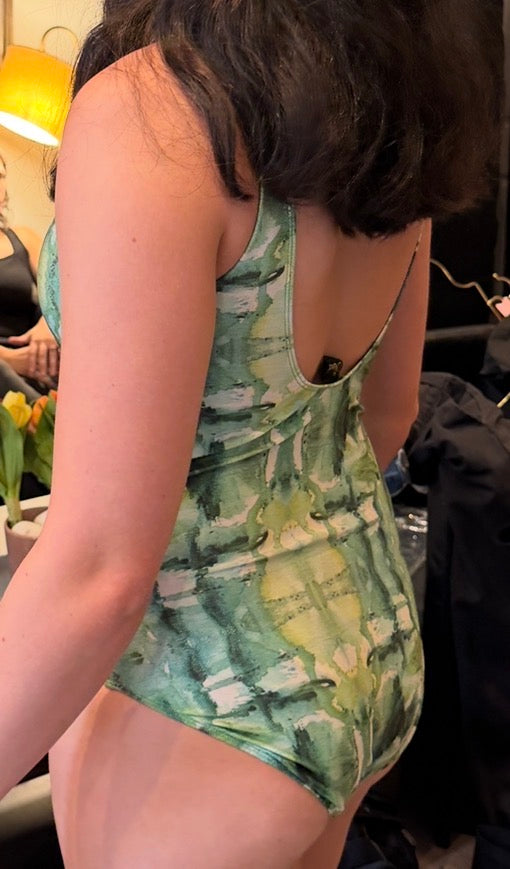 Back view of a green floral scoop back one piece swimsuit with high coverage, by C. Monet Atelier