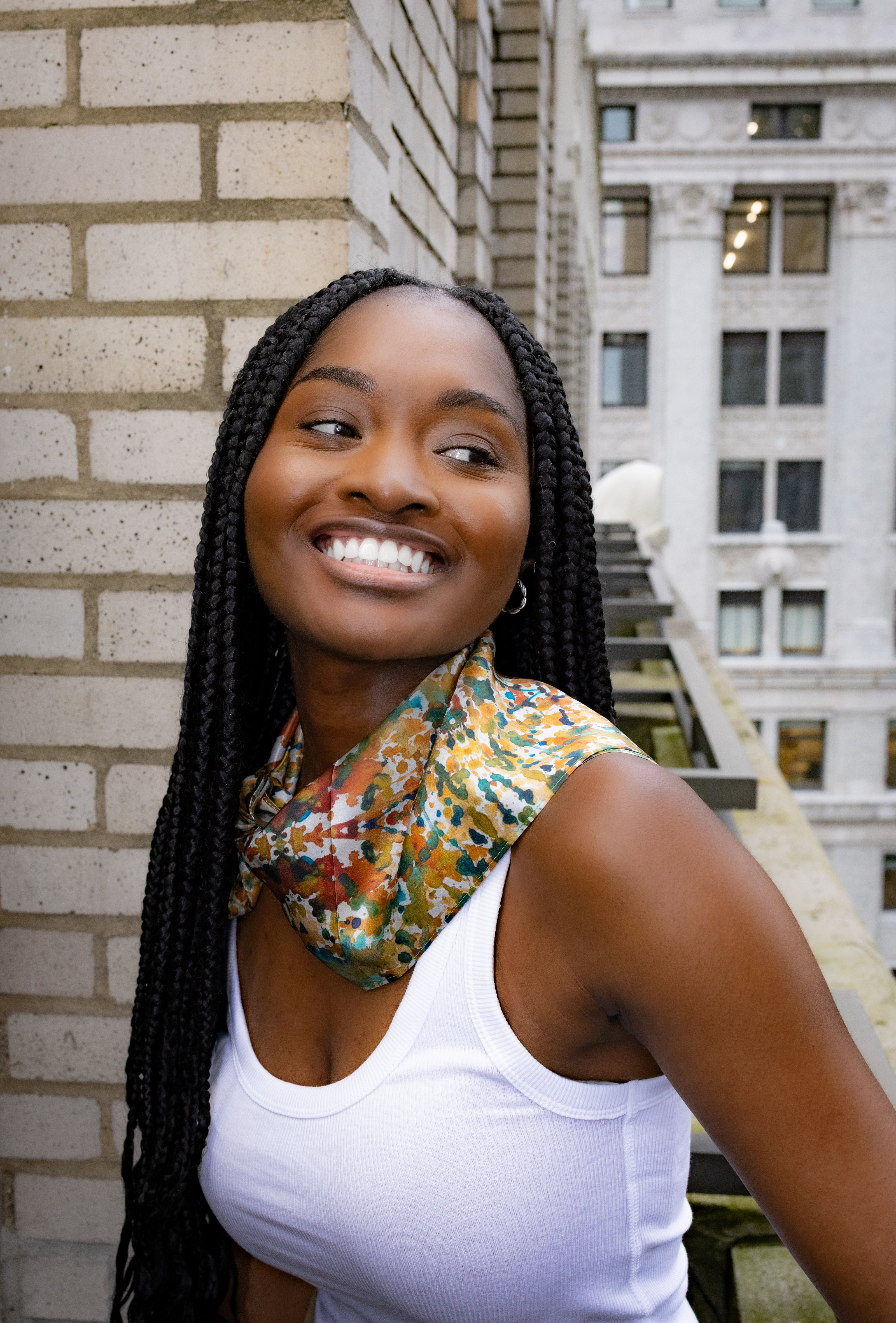Colorful silk scarf worn by woman on rooftop – Cierramonet fashion style