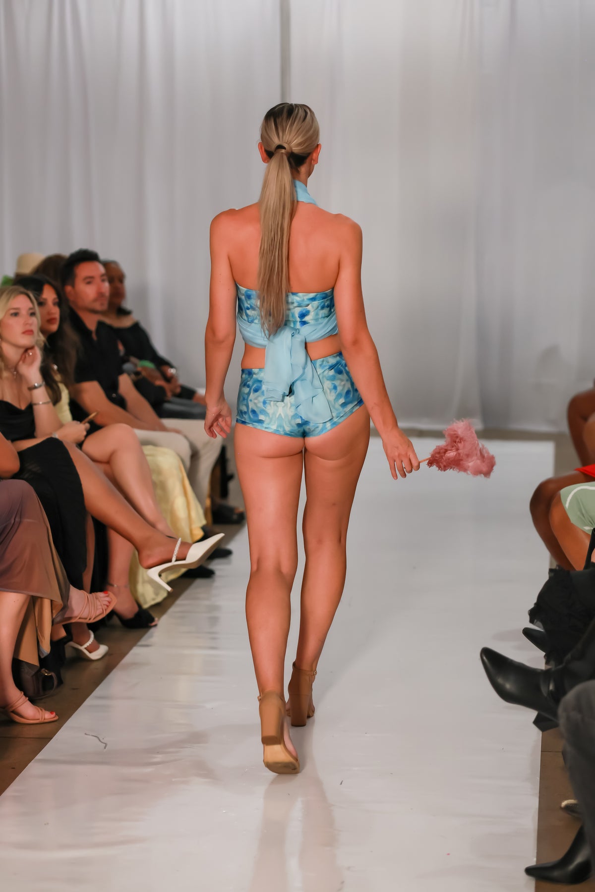 Back view of woman walking runway in Sky Blue swim shorts